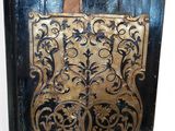 an old black and gold mail box sitting on top of a wooden table