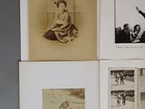 many old photographs of women and men on the wall