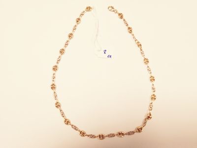 gold plated chain necklace with a flower design on a white background