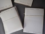 several pieces of paper with writing on them sitting on a table