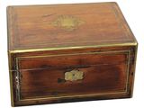 an antique wooden box with a brass - plated lid on a white background