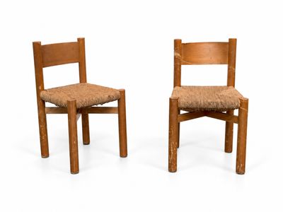 two chairs that are sitting side by side on a white surface