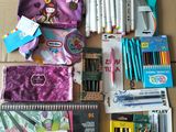 many school supplies laid out on the floor next to each other