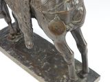 bronze statue of a man riding a horse with a saddle