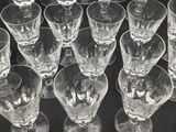 many empty wine glasses lined up on a table