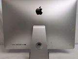 a silver apple computer sitting on top of a white table
