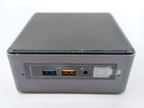 a small computer sitting on top of a white table
