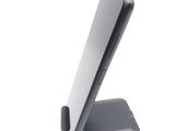 a cell phone sitting on a stand on a white surface