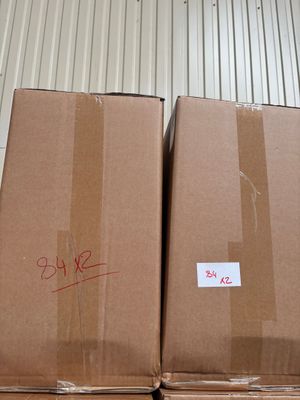 cardboard boxes are stacked on top of each other in a warehouse