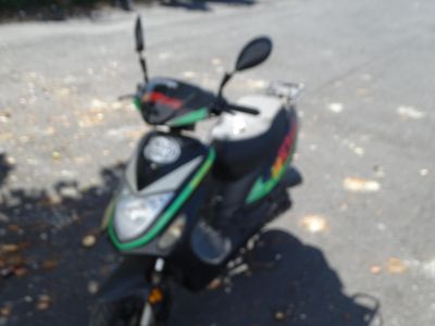 a motor scooter parked on the side of the road