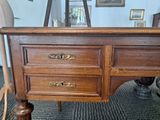a wooden desk with two drawers on top of it