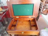 a small wooden box with a green lid on a table