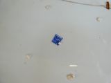 a white plate with a blue sticker on it