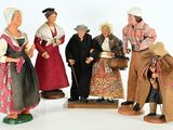 five figurines of people dressed in traditional clothing