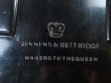 a close up of a metal object with a crown on it