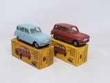 three toy cars sitting on top of boxes on a white surface