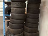 many tires stacked up on a pallet in a warehouse