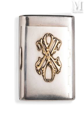 a silver and gold cigarette case with a cross on it