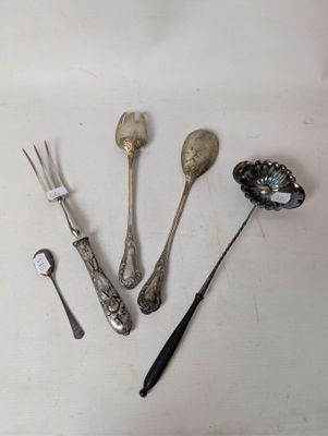 several spoons, forks, and spoon rest on a white surface
