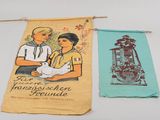 two tea towels hanging on a clothesline with a picture of a man and a woman holding a baby