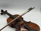 a violin sitting next to a clock on a table
