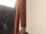a mirror and a pair of shoes on a stand