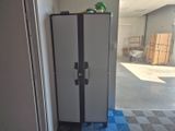 a refrigerator that is sitting in the corner of a room