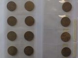 a lot of coins that are on display in a case