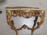 a gold table with a marble top on it