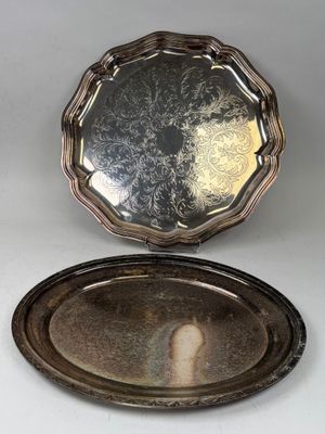 a silver plate with a mirror on top of it on a table