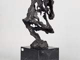 sculpture of a horse on a black marble base on a white background