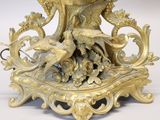 a gold vase with a bird and flowers on it