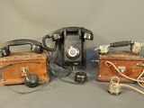 two old telephones sitting next to each other on a table