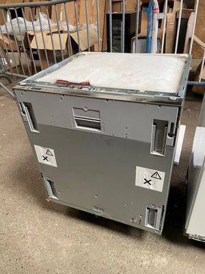 two refrigerators sitting next to each other in a room