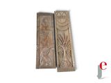 pair of carved wooden door handles with a design of flowers and leaves