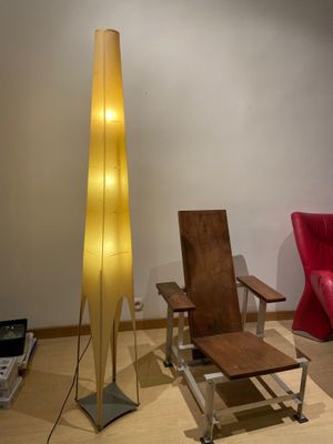 two chairs and a table in a room with a floor lamp