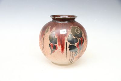 a small vase with a design on it sitting on a table