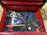 a red tool box filled with various tools on the floor
