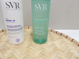 a bottle of water and a bottle of lotion sitting on a basket
