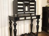 a black and white birdcage sitting on a wooden table
