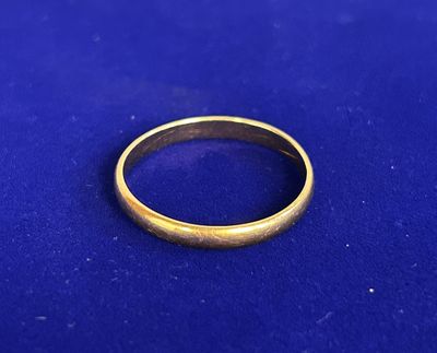 a close up of a gold ring on a blue surface