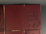 three red books with drawings of a man and a woman on them