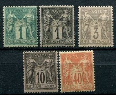 a group of four different postage stamps on a black surface