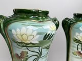 two vases that are painted with flowers on them