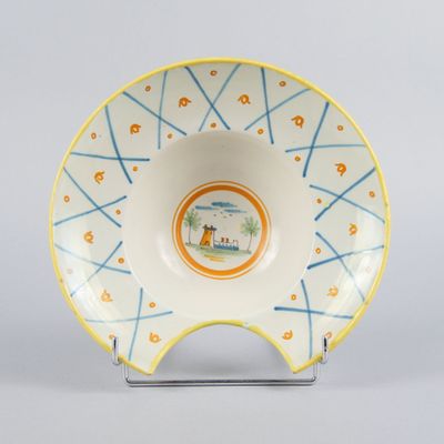 a white bowl with a blue and yellow design on it