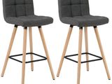 pair of grey fabric bar stools with wooden legs