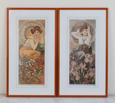 a pair of two framed art prints of a woman and a cat