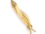 a close up of a gold leaf brooch on a white background