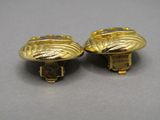 pair of gold tone buttons with a leaf design on them