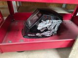a helmet that is sitting on top of a red cart